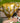Children celebrating a football-themed birthday party with a trophy and green balloons.