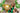 Mum and child smile with a big trophy balloon at a football-themed children's birthday party