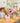 The family celebrates a summer themed birthday around a colourfully laid table - with balloons and a pink leopard foil balloon as party decorations.