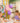 Unicorn themed children's party, where children sit around a decorated birthday table surrounded by balloons and a unicorn foil balloon